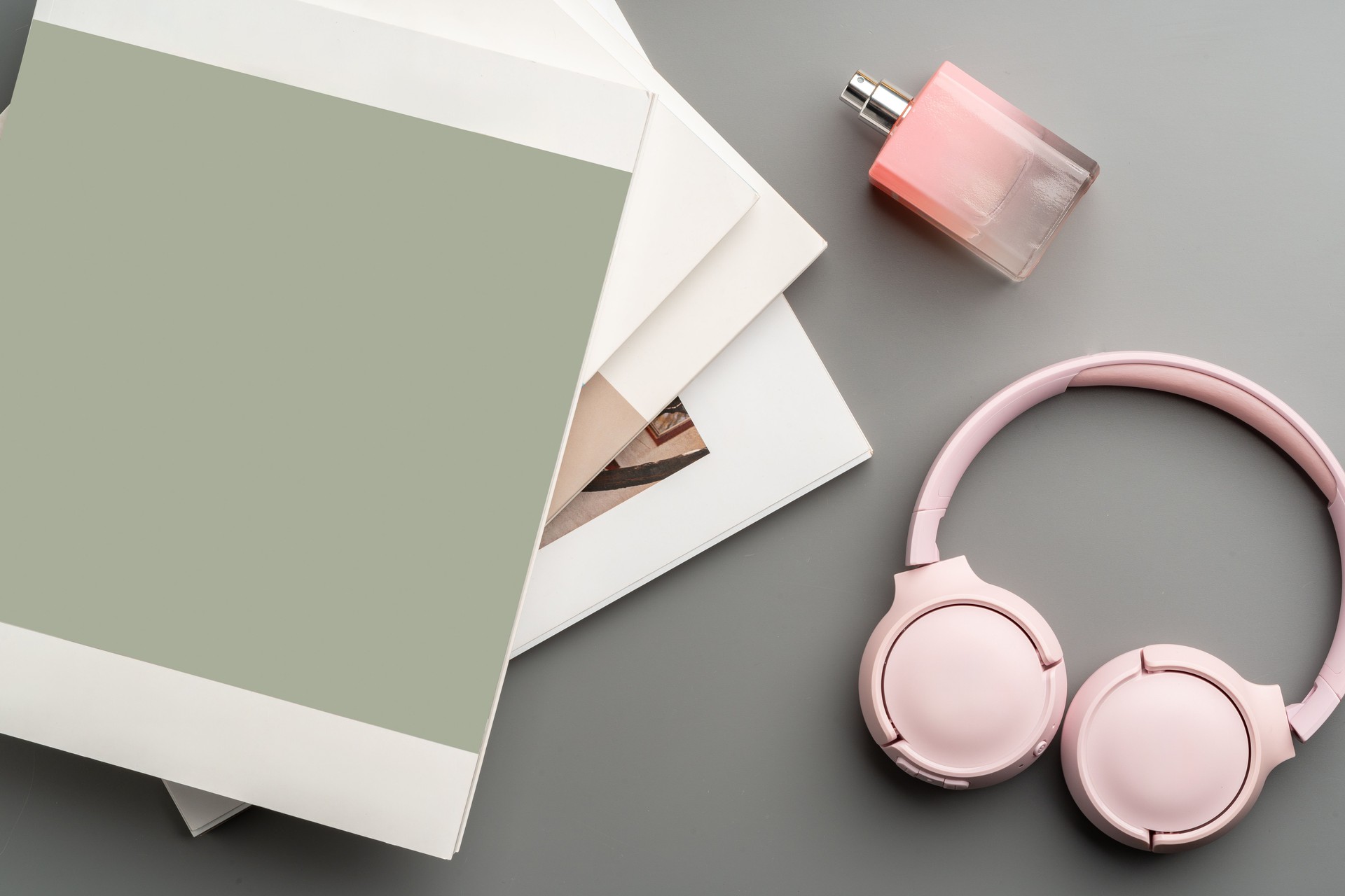Stylish pink headphones and sunglasses on a pastel background